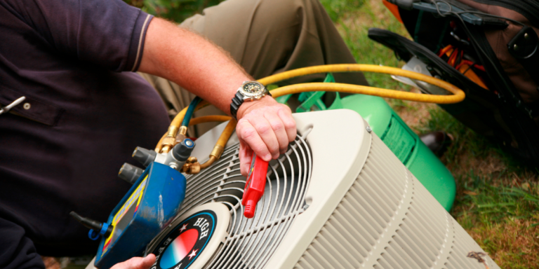 hvac specialist fixing an air conditioning unit