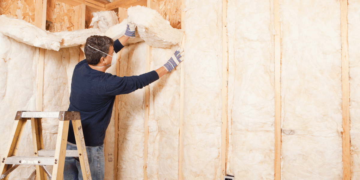 carpenter installing insulation